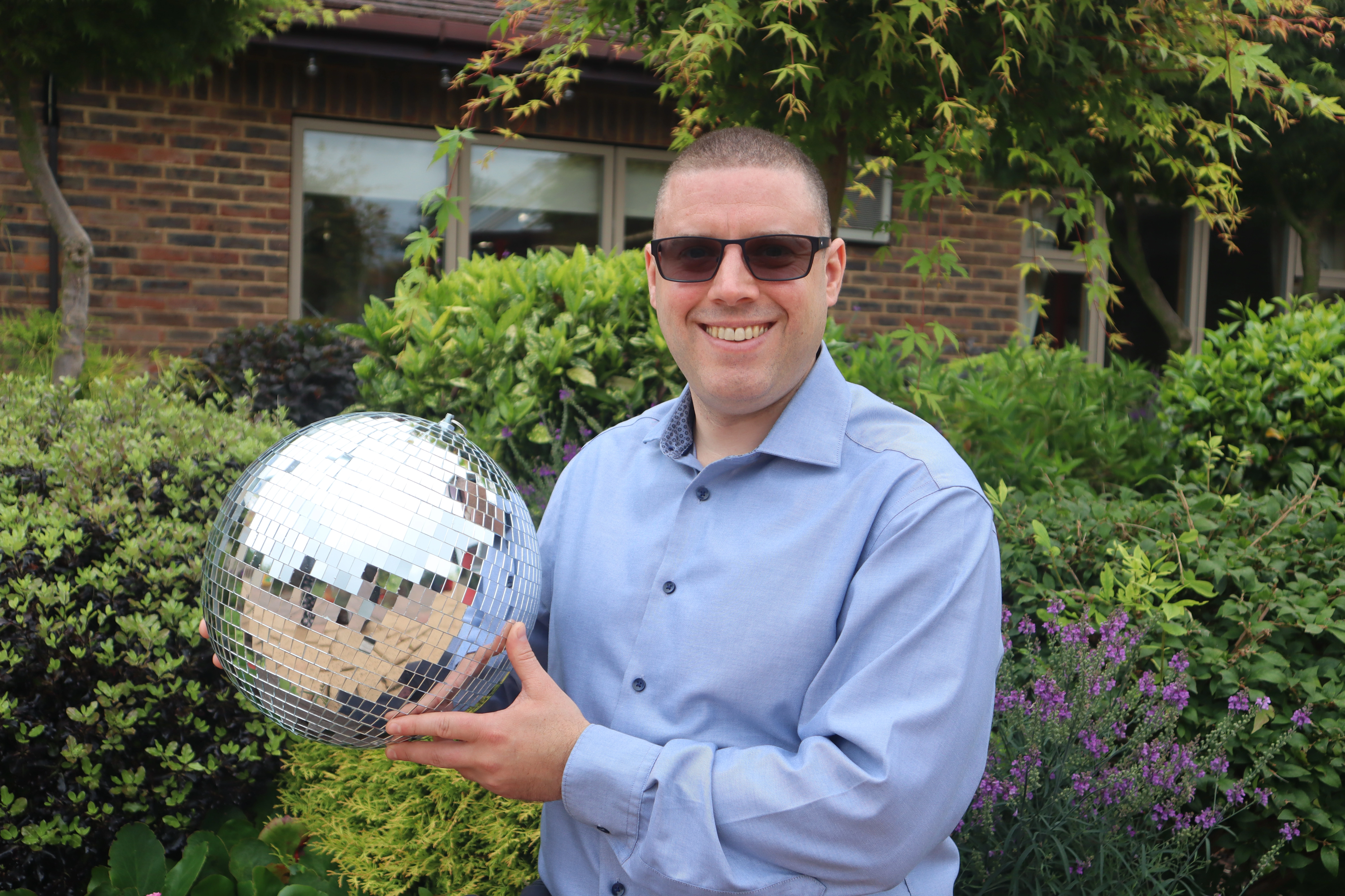 A photo of Paul holding the Strictly St. Rocco's Glitter ball