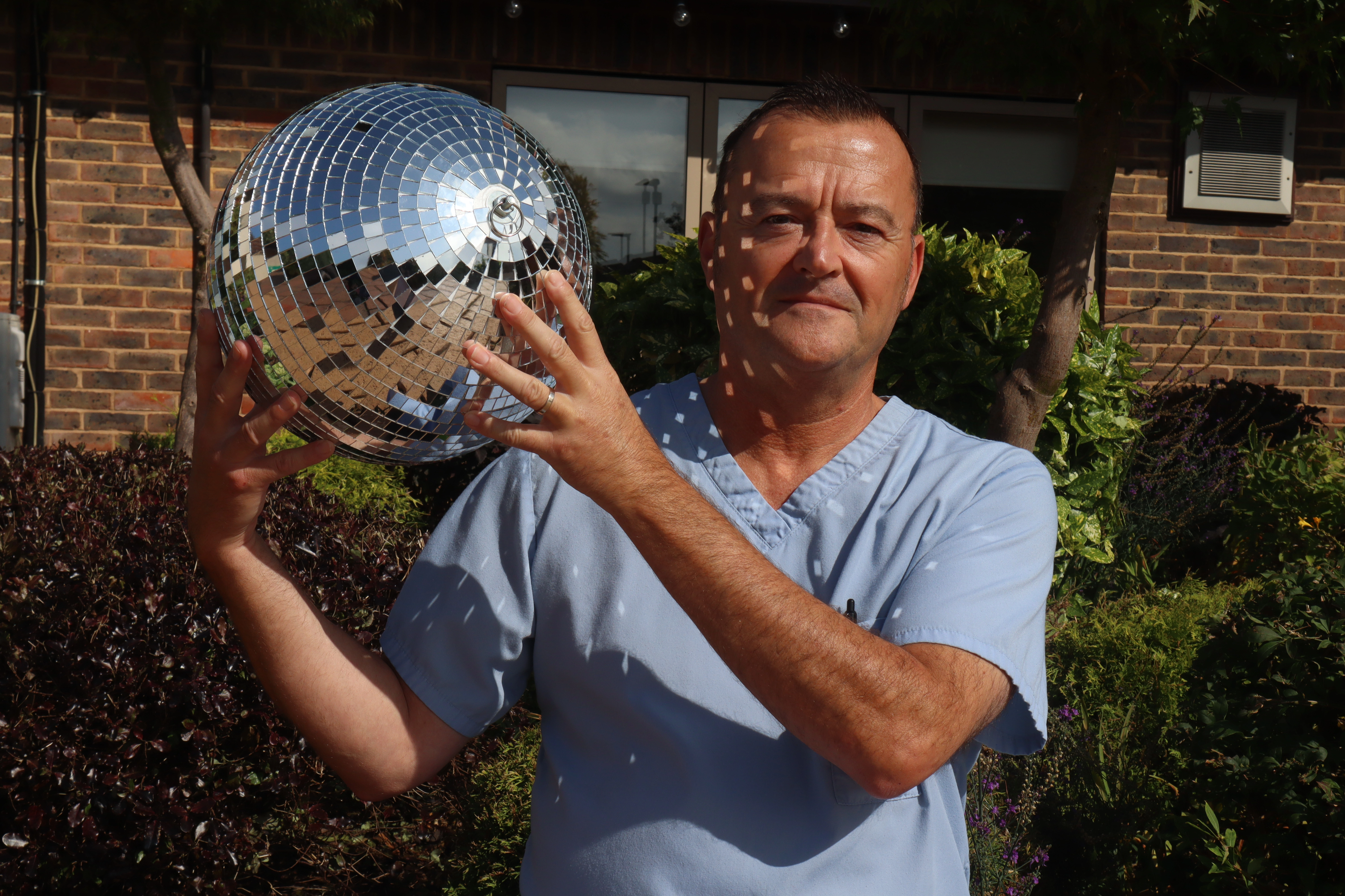 A photo of Paul holding the Strictly St. Rocco's Glitter ball