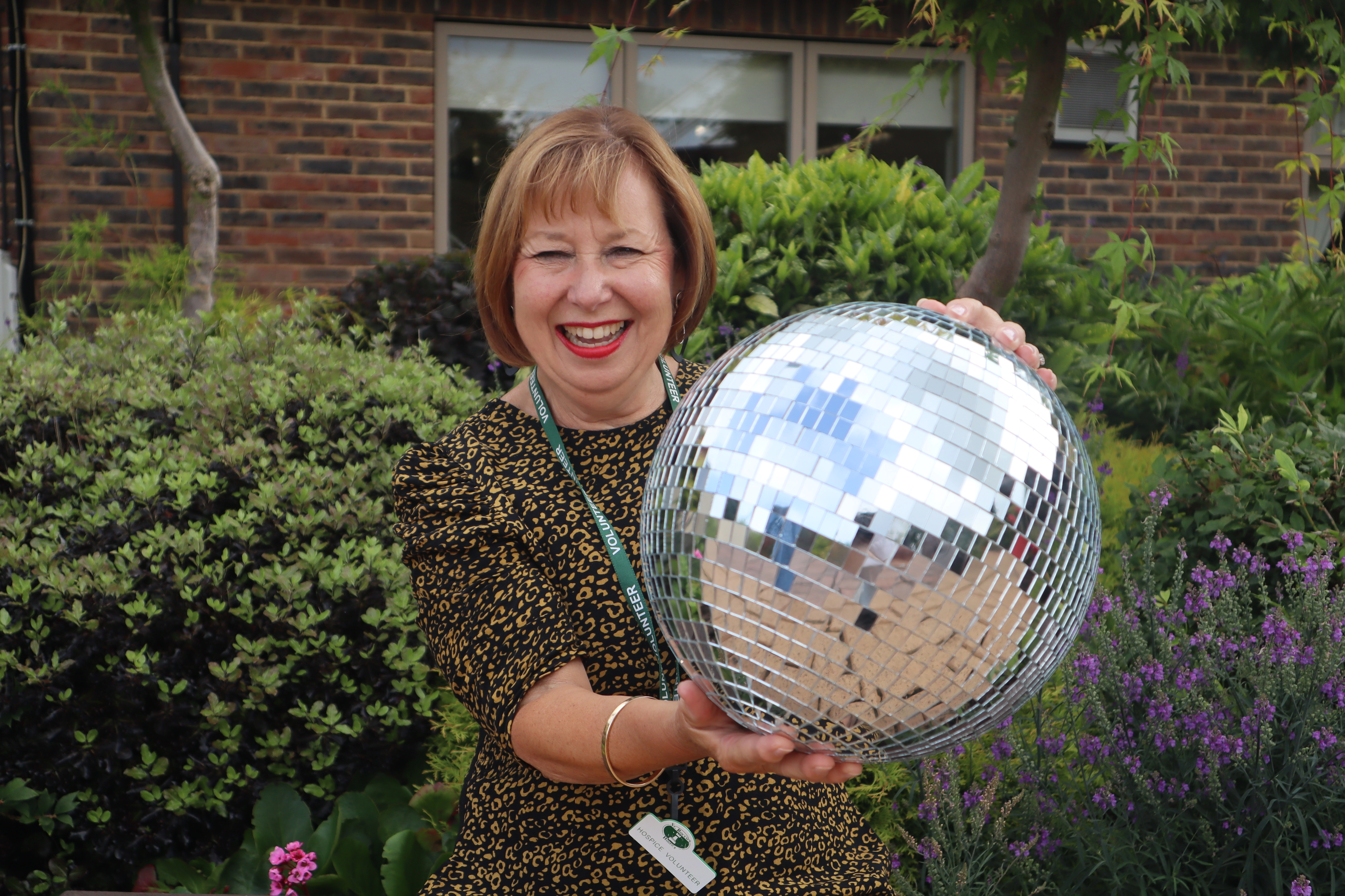 A photo of Ann holding the Strictly St. Rocco's Glitter ball