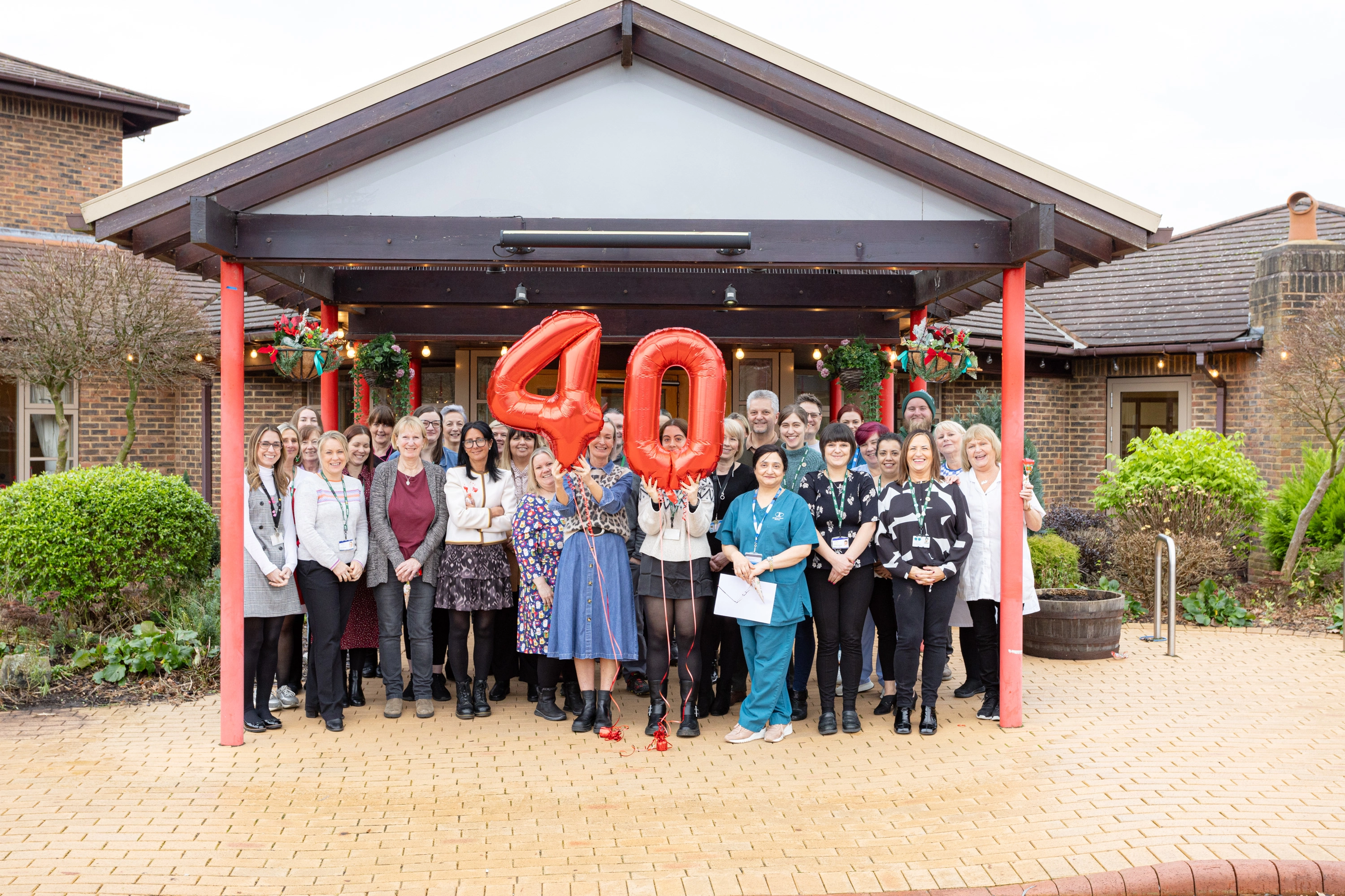 A photo of St. Rocco's Staff grouped together for the 40th Anniversary of the Hospice